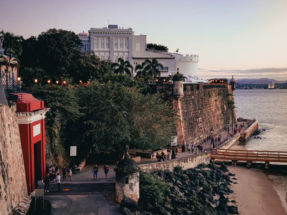 The Old San Juan city wall and gate along the waterfront at dusk